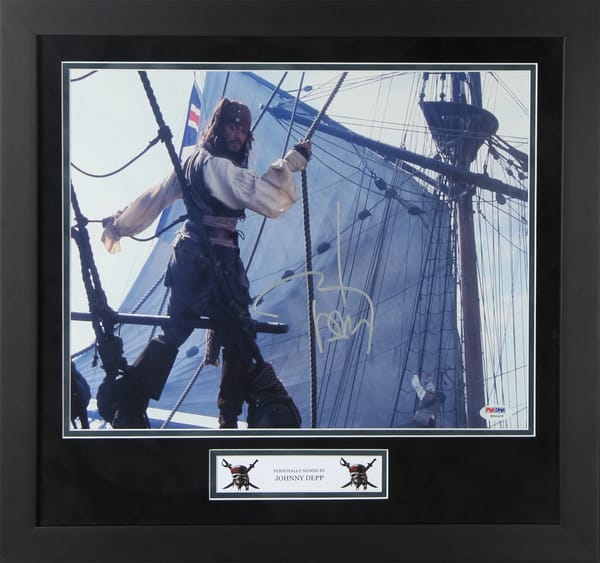 Johnny Depp Signed “Pirates of the Caribbean” Poster (PSA)