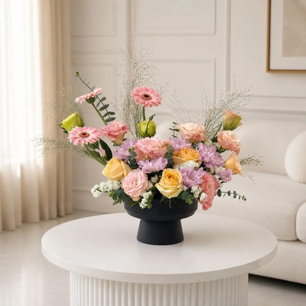 Mix of pink and yellow in black vase